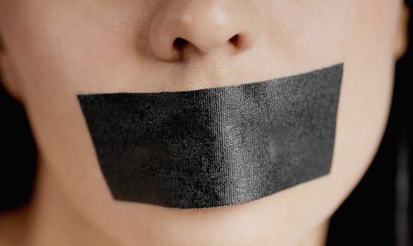 Photo d'une personne avec du ruban adhésif sur la bouche